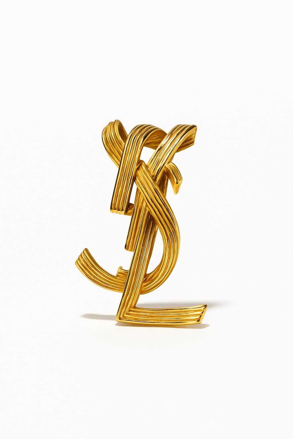 Yves Saint Laurent statement vintage logo cuff bracelet close up authentic accessories on white background 