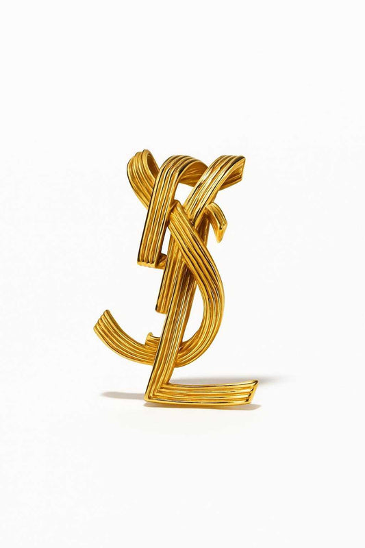 Yves Saint Laurent statement vintage logo cuff bracelet close up authentic accessories on white background 