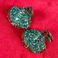 Close-up of Yves Saint Laurent Rive Gauche vintage statement earrings with turquoise and red rhinestones  showing the imperfections 