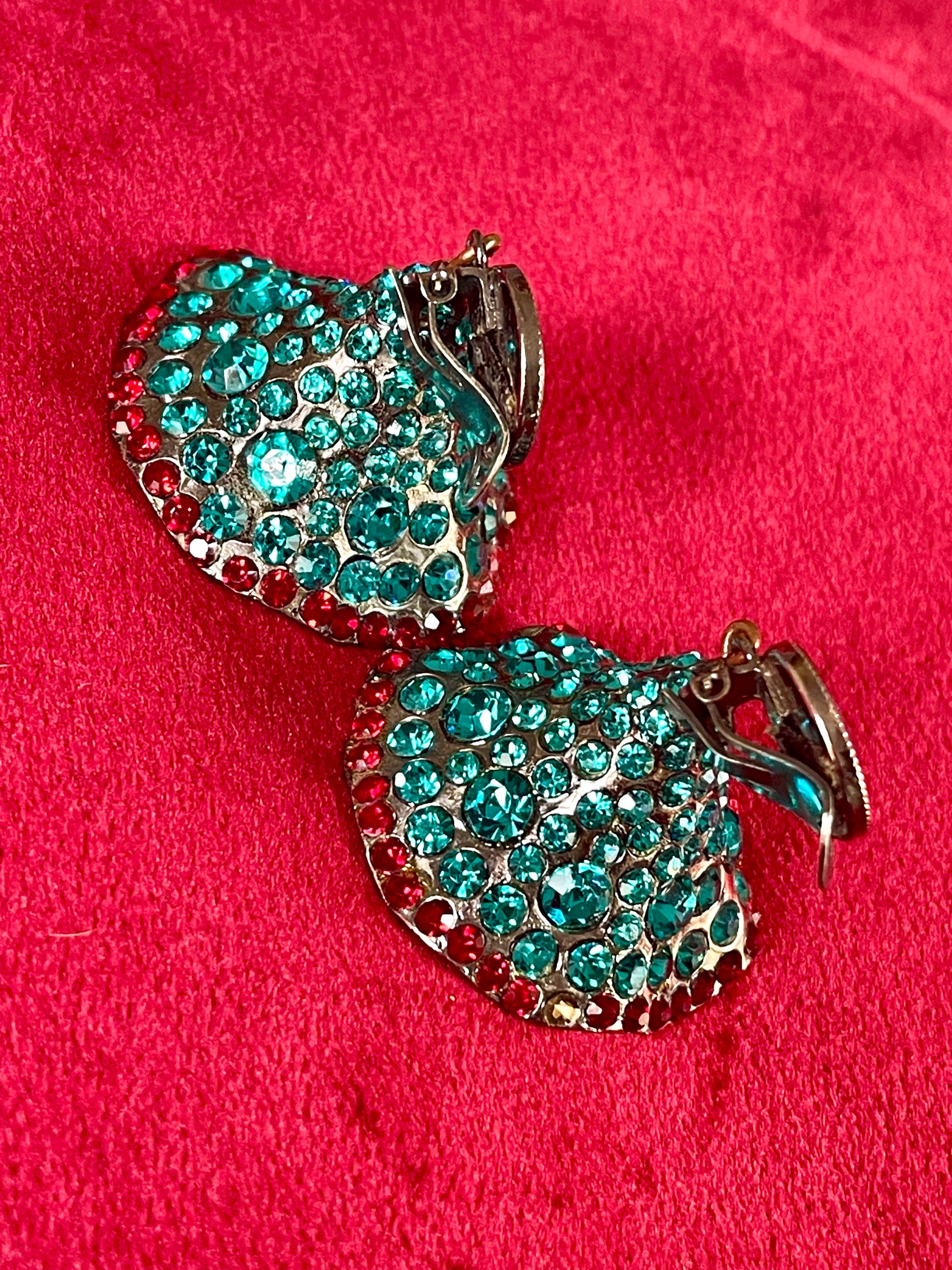 Close-up of Yves Saint Laurent Rive Gauche vintage statement earrings with turquoise and red rhinestones  showing the imperfections 