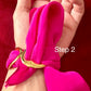 Hand wearing a bright Dior pink scarf bracelet with a gold tone on a red background, labeled 'Step 2'.