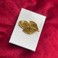 Rare Vintage Yves Saint Laurent 80s 90s gold tone leaf brooch excellent condition on white and red background 