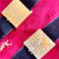 Top view Fashion Bracelet makeup Yves Saint Laurent vintage 2000 displayed with YSL pins on a red velvet background 