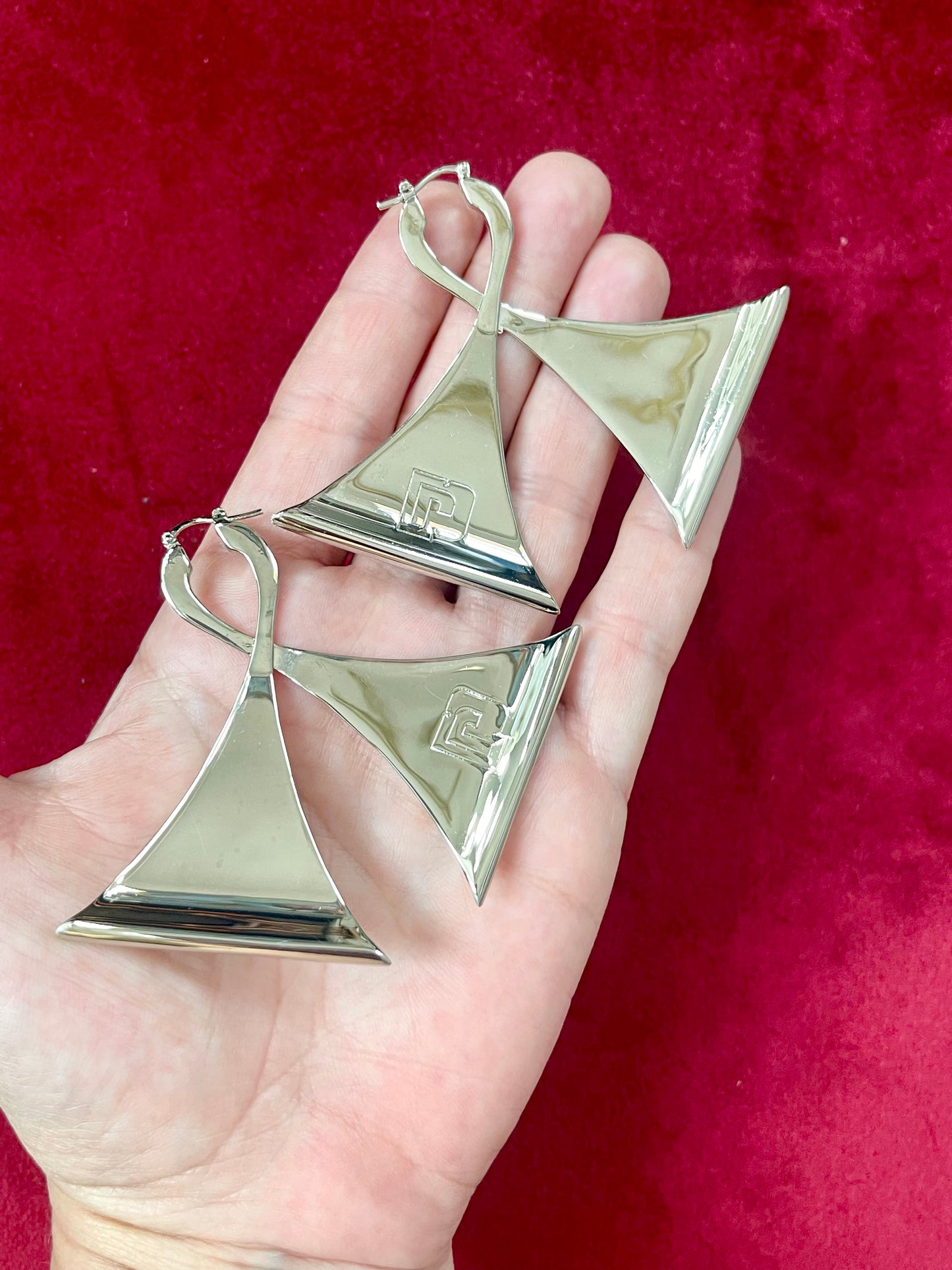 Vintage Paco Rabanne silver-tone geometric sculptural statement earrings placed on hand showing frontside 