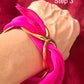 Dior silk scarf tied around gold bracelet styling example Step 3