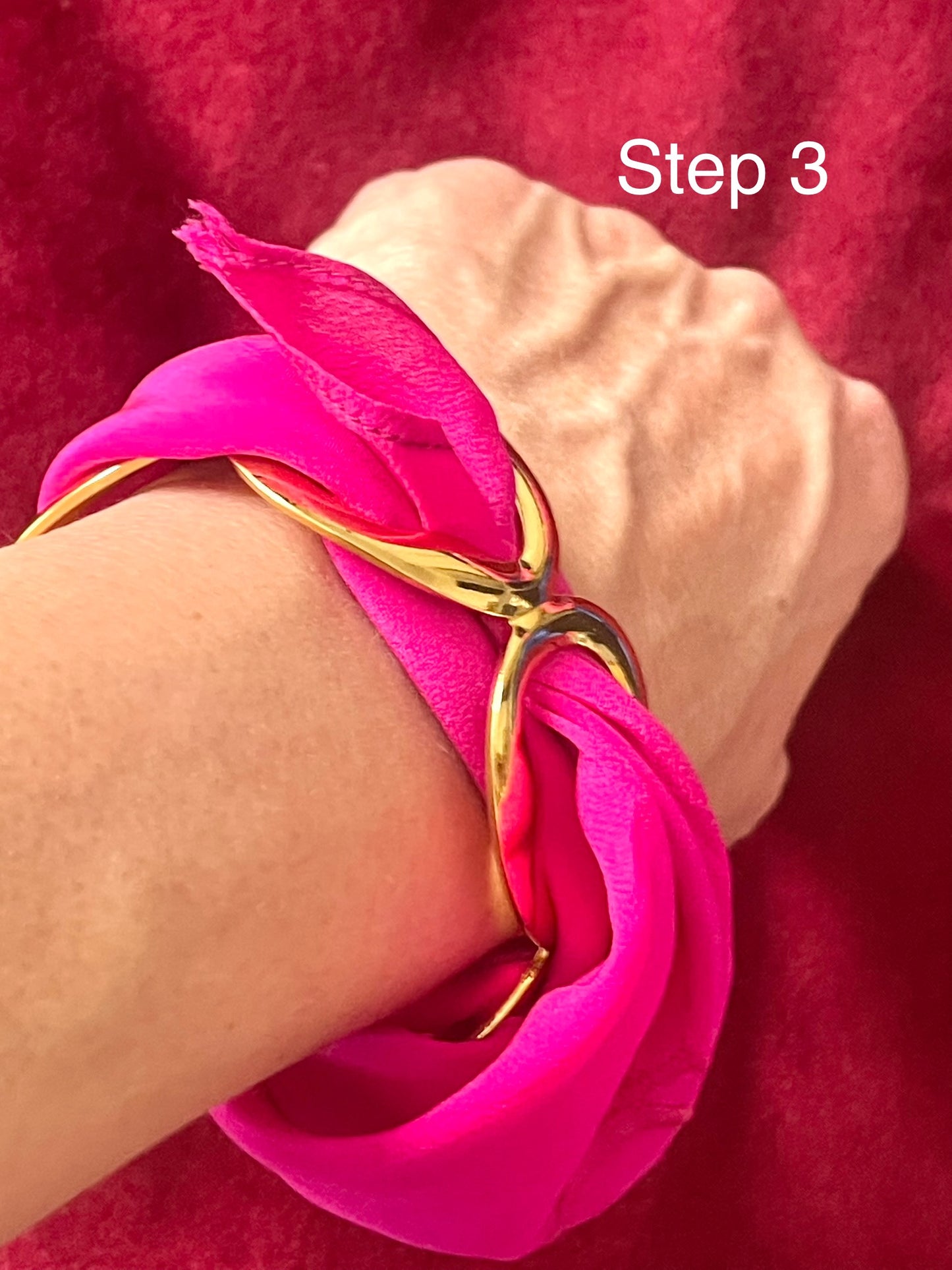 Dior silk scarf tied around gold bracelet styling example Step 3