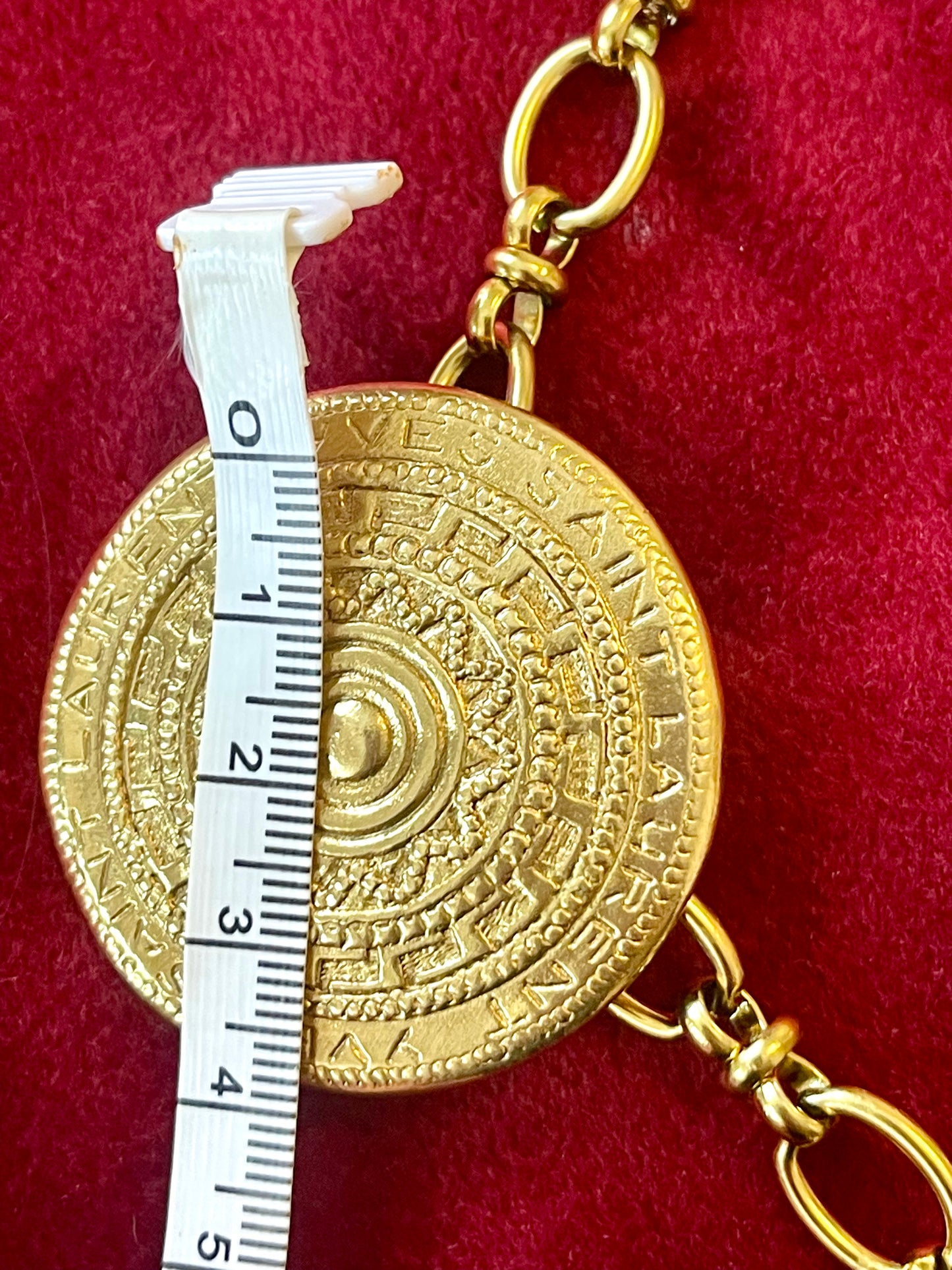 4 cm Yves Saint Laurent vintage scarf holder Gold tone on red fabric using a measuring tape 