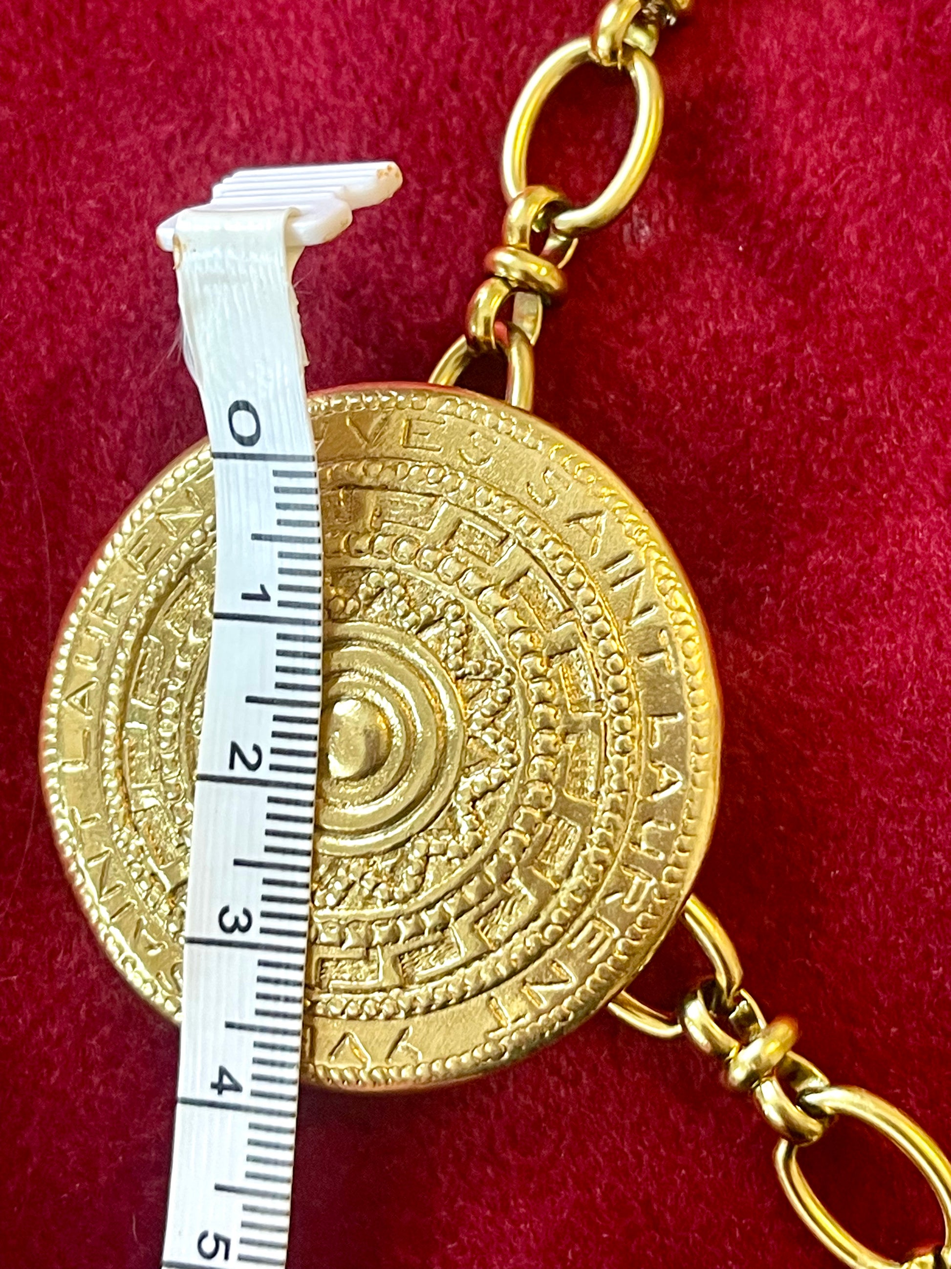 4 cm Yves Saint Laurent vintage scarf holder Gold tone on red fabric using a measuring tape 
