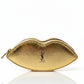 Gold lip-shaped makeup bag with YSL logo on a white background