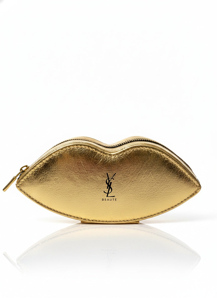Gold lip-shaped makeup bag with YSL logo on a white background