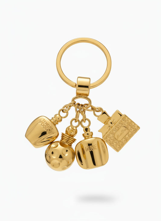 Christian Dior vintage Gold keychain with multiple charms Dolce Vita on a white background 