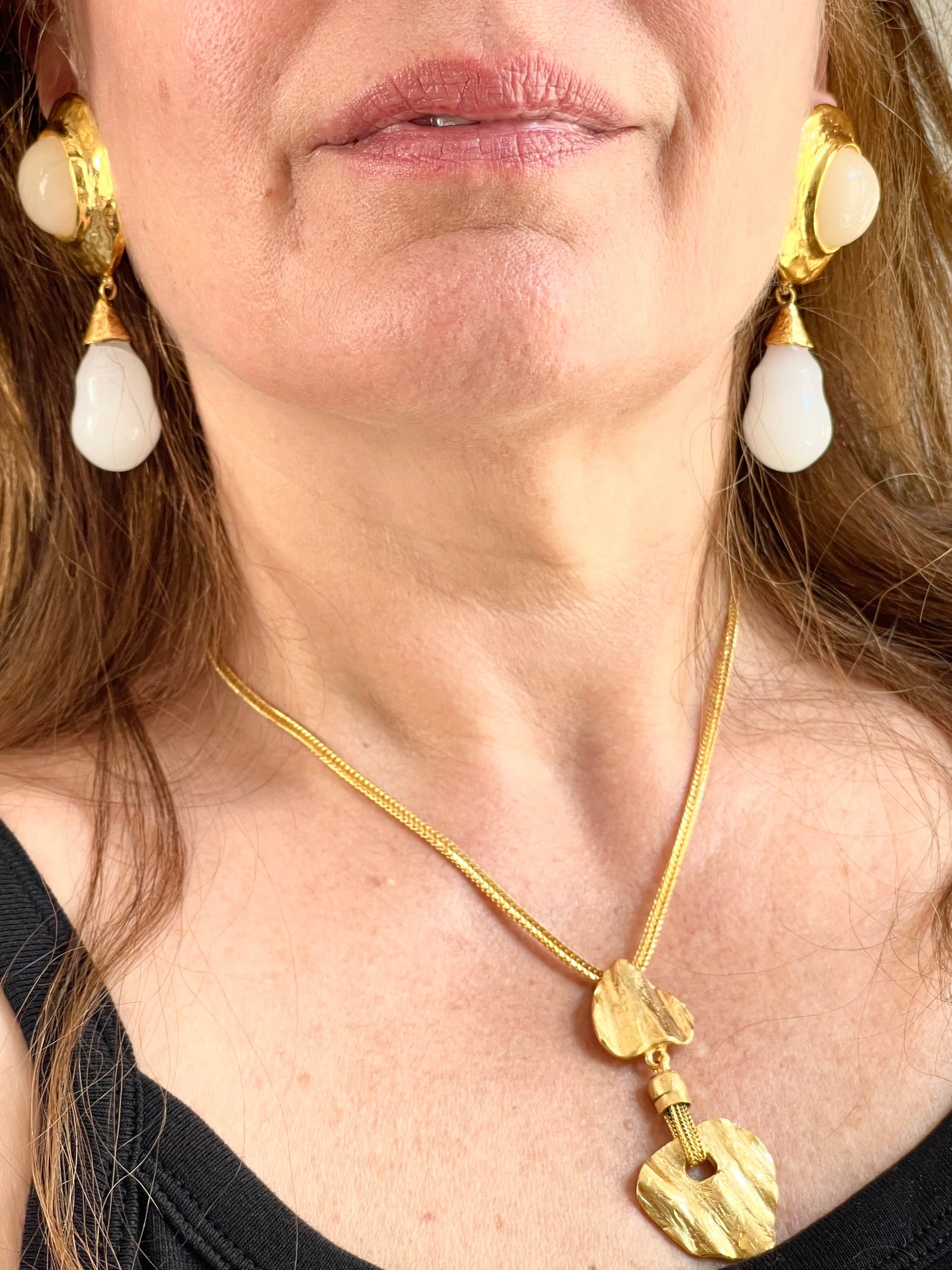 Worn by model a close up on Vintage Arty Yves Saint Laurent gilded necklace. Gold plated 18KG with Vintage YSL earrings 