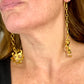 Side view of long Yves Saint Laurent drop earrings showing length and chain Worn by model