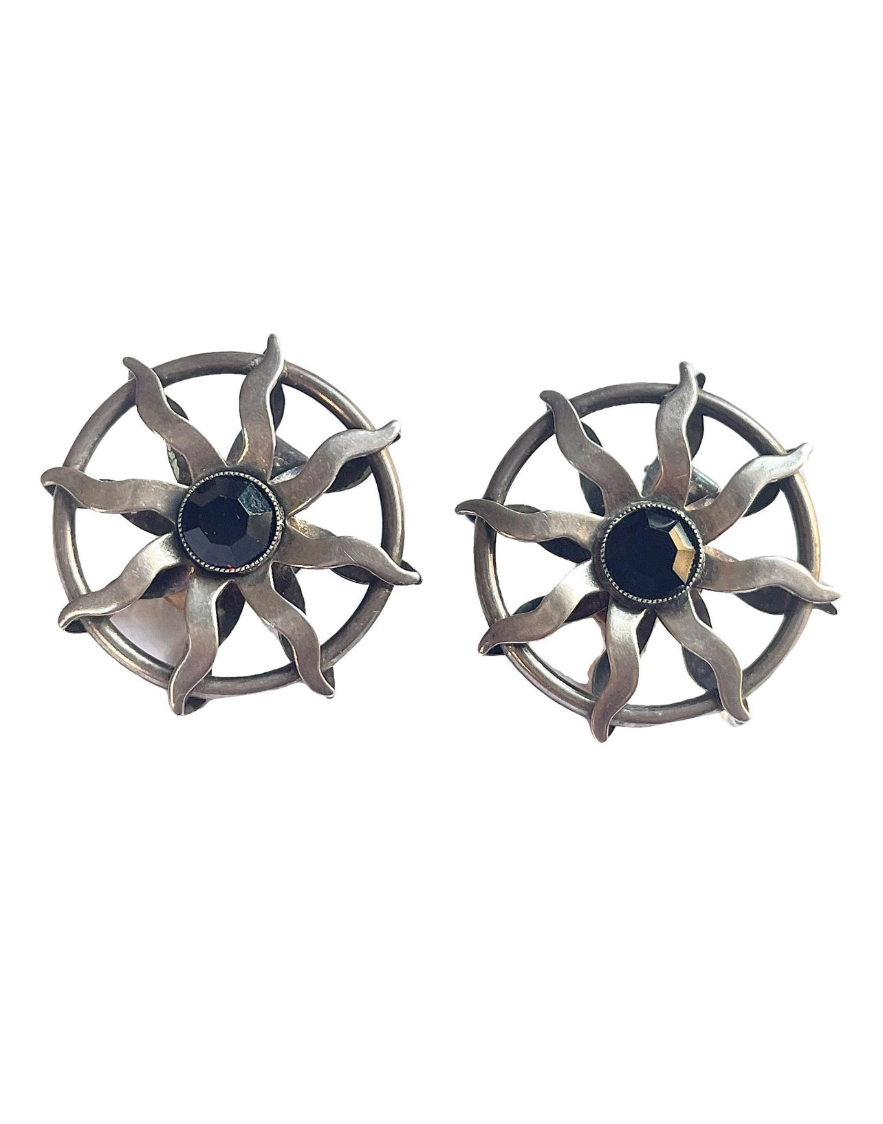 Vintage Paco Rabanne sun-design earrings in silver tone with black faceted stones, shown against a white background.