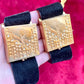 On hand Two Fashion Bracelet makeup Yves Saint Laurent vintage 2000 displayed with YSL pins on a red velvet background 