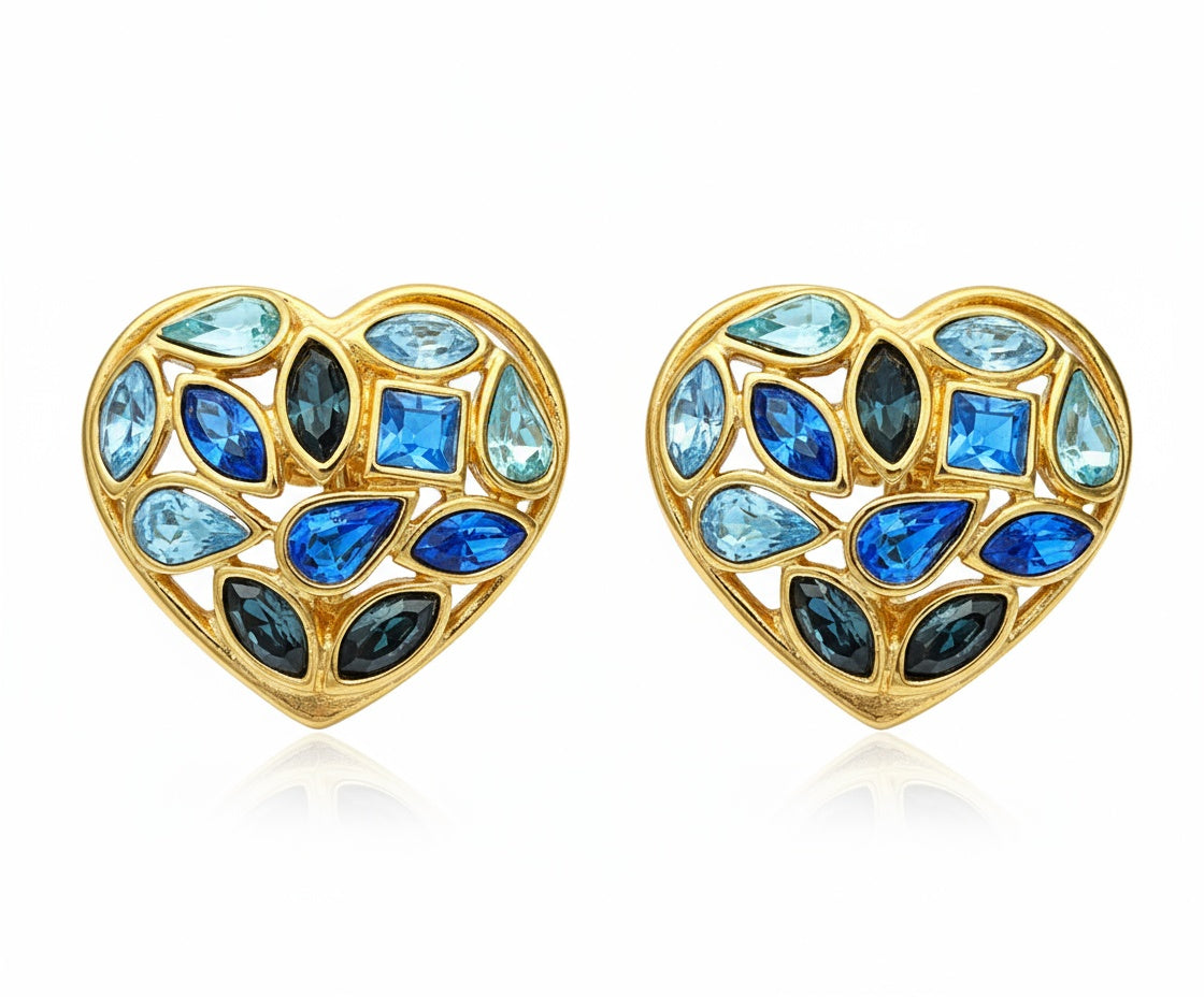Pair of 3 cm gold-tone vintage Yves Saint Laurent heart-shaped clip-on earrings decorated with multi-coloured crystals, displayed on a white background