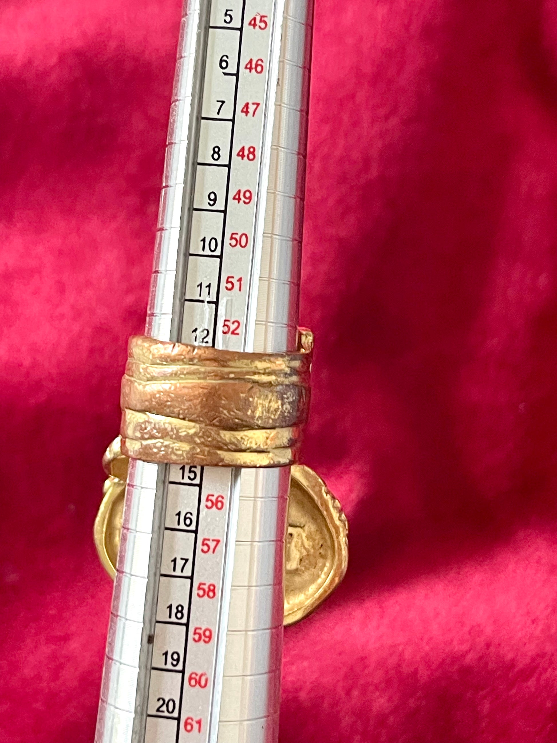 Measurement back side of a vintage YSL Arty ring showing the intricate textured gold band and raised turquoise nacre centerpiece.