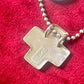 Close-up of back side vintage YSL jewelry, cross pendant necklace Showing the hallmarks 