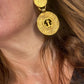 Side view of vintage YSL anchor statement earrings showing textured finish and clip-on backs worn by model