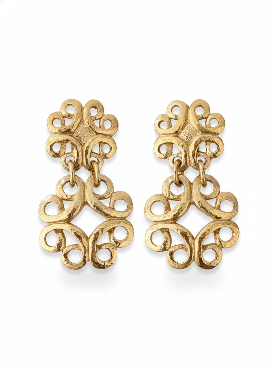 Front view of vintage gold-tone Yves Saint Laurent statement drop earrings displayed on A white background 