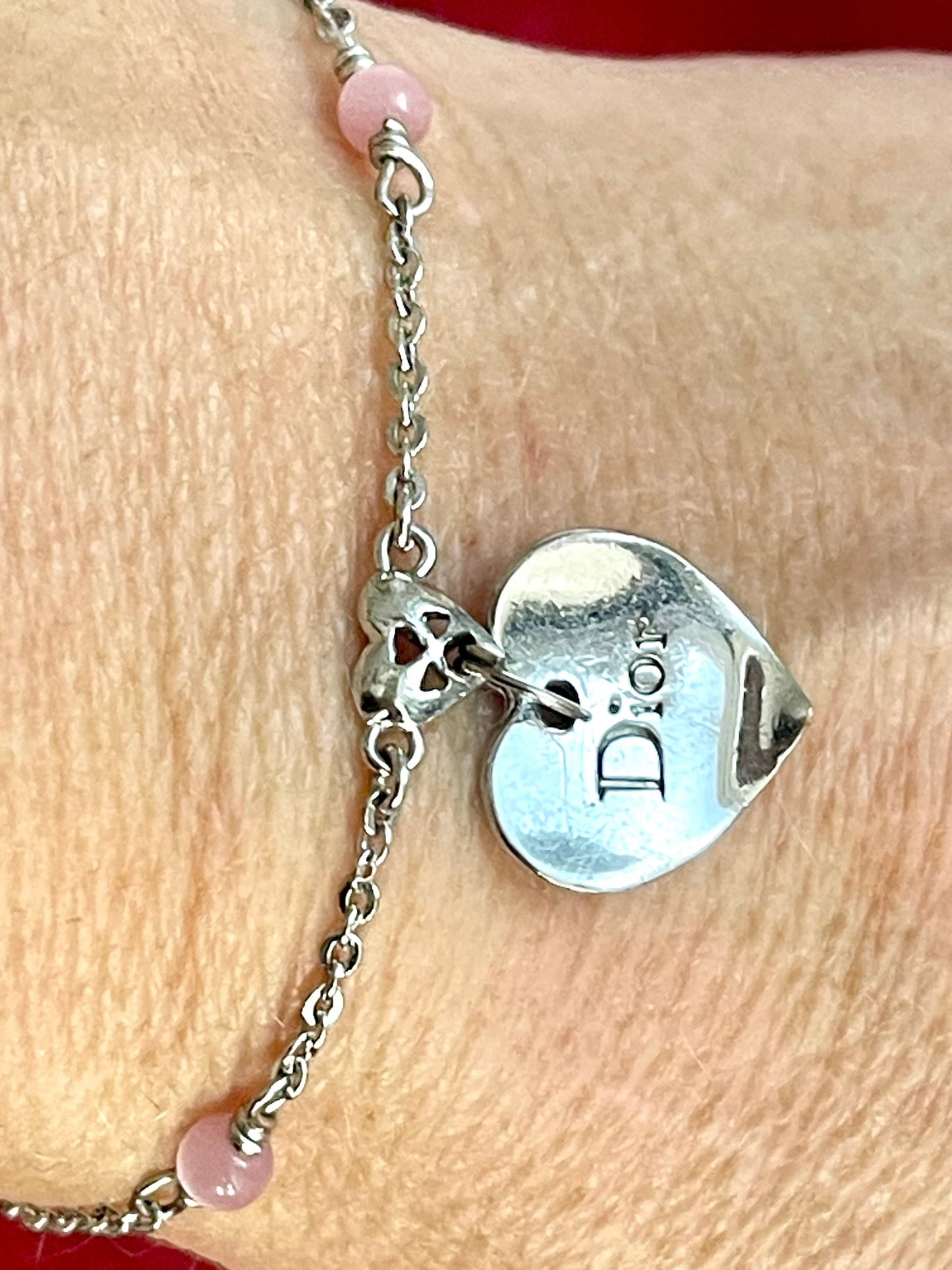 Close up on pendant charm of Vintage Dior silver tone rose beads chain bracelet with D charm signed 