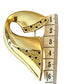 Vintage Christian Dior gold-tone sculptural brooch decorated with black and clear rhinestones, displayed with a measuring tape 