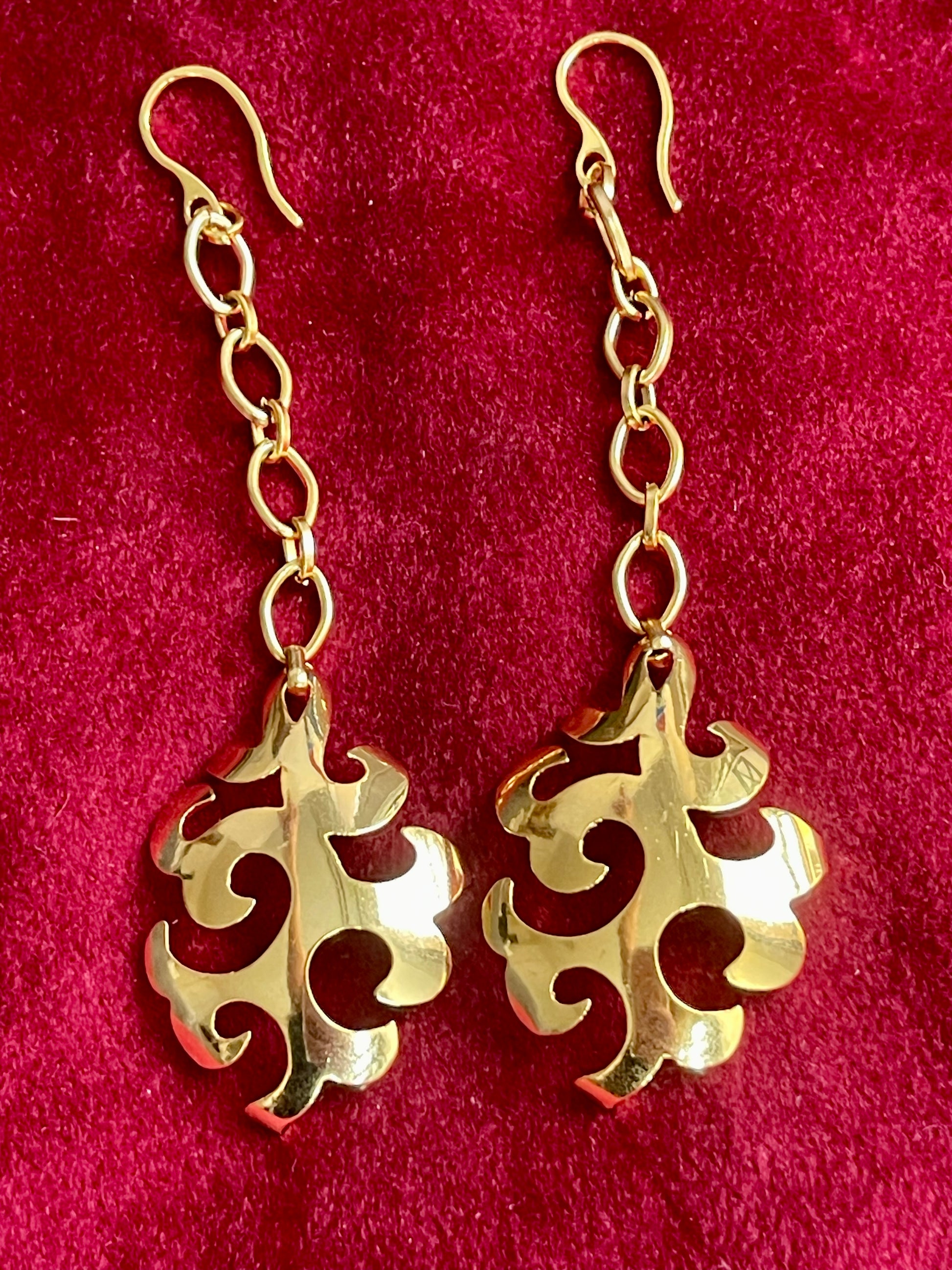 Close-up detail of 18K gold plated YSL pendant used in earrings