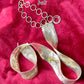 Upper view vintage silver Paco Rabanne mesh belt on red velvet background.