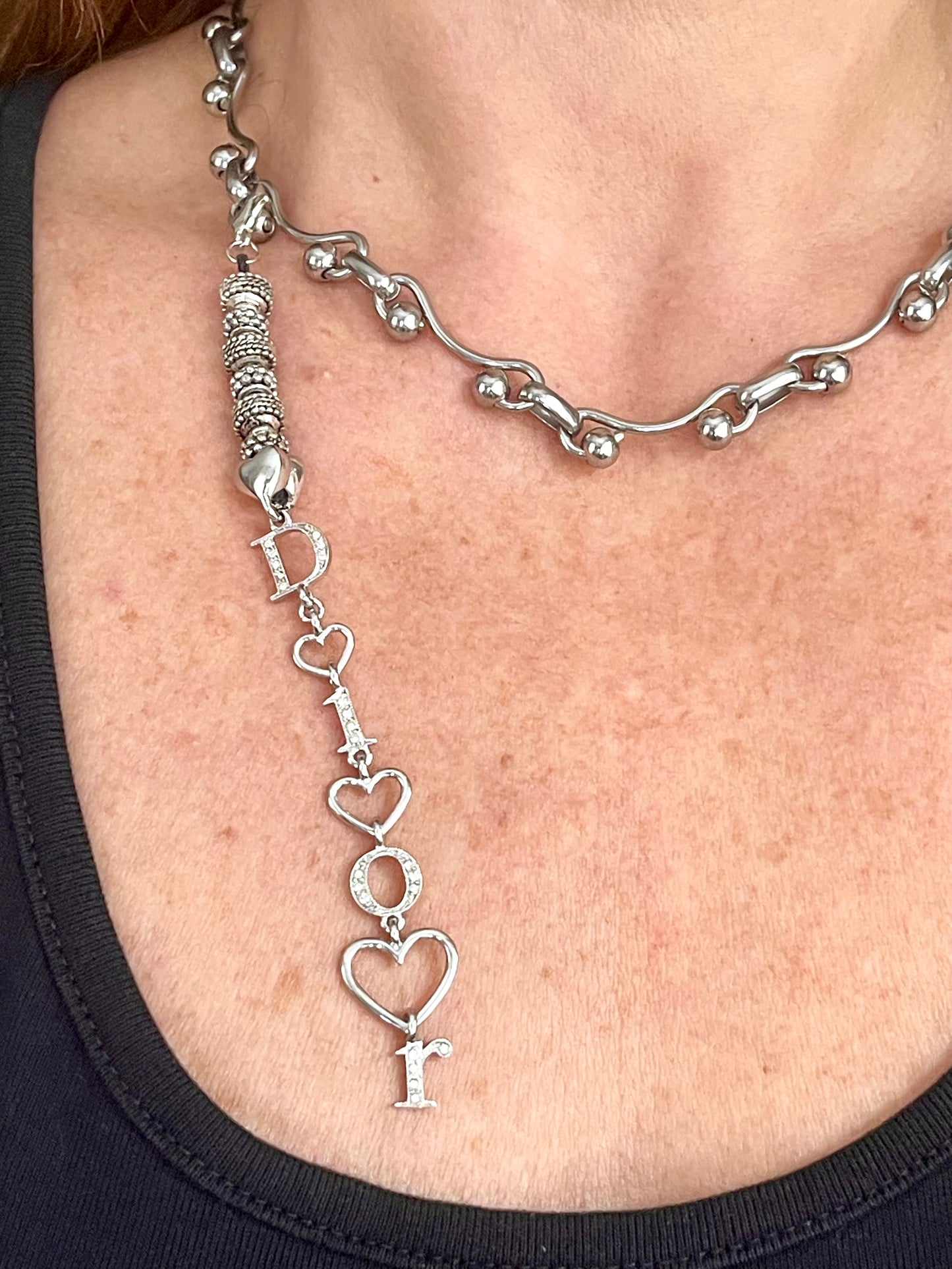 Upcycled Dior pendant necklace worn by model, adjustable silver-tone stainless steel chain