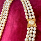 Vintage Yves Saint Laurent faux pearl statement necklace worn on model, showcasing multi-strand design and bold gold clasp at the neckline.