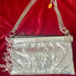 One of a kind handmade Paco Rabanne repurposed silver pixel mesh bag On red background 