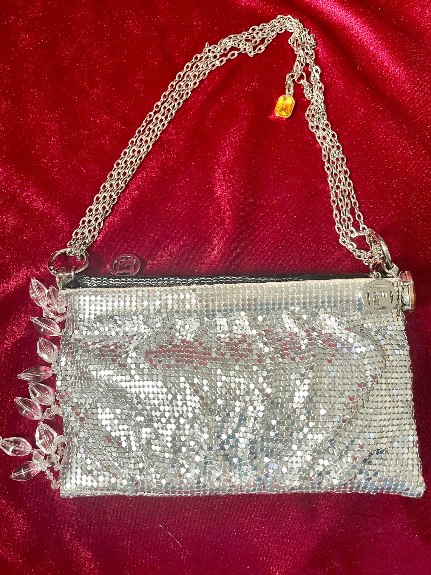 One of a kind handmade Paco Rabanne repurposed silver pixel mesh bag On red background 