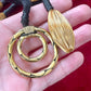 Close-up of vintage Yves Saint Laurent YSL gold tone scarf holder signed Made in France held by hand