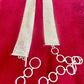 Close up on vintage silver Paco Rabanne mesh belt on red velvet background.