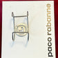 Back view of signed Paco Rabanne Parfums cuff bracelet on white and red background 