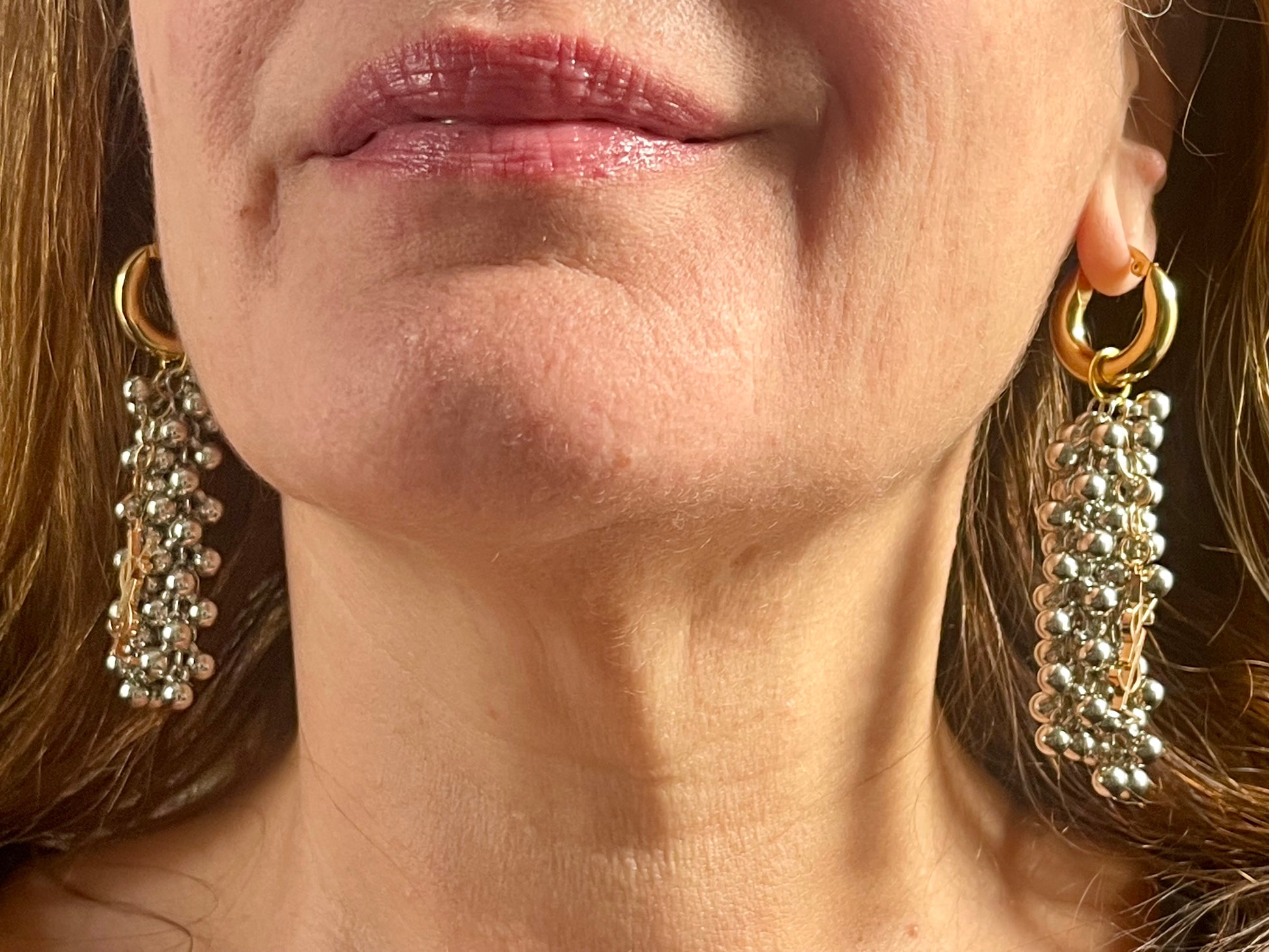 Pair of Gold and silver earrings with pearl-like beads and YSL Yves Saint Laurent charms Worn by model 