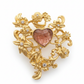 golden brooche with brown resin heart