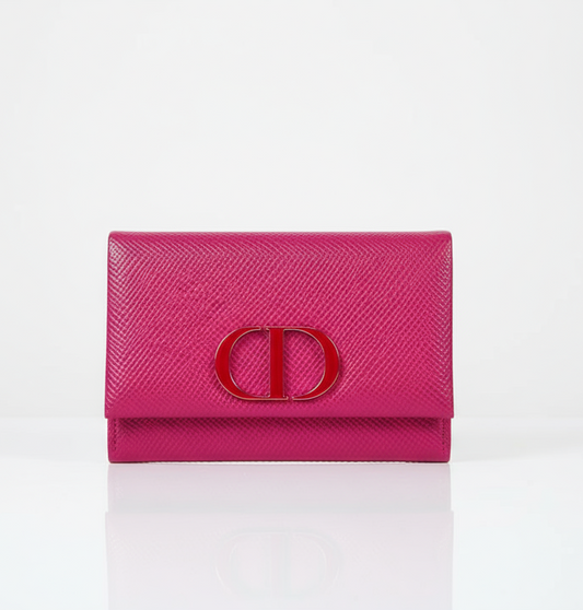 Pink wallet mirror from Dior with a CD logo on a white background