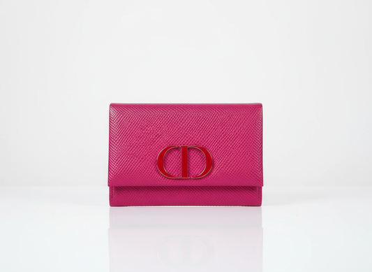 Pink wallet with dior logo on a white background
