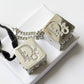 Front view of vintage Dior Play dice-shaped bag charm with silver finish and embedded crystals