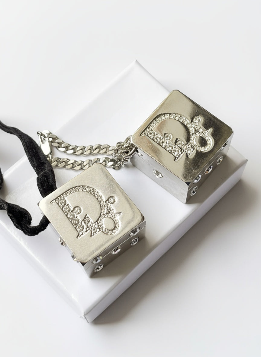 Front view of vintage Dior Play dice-shaped bag charm with silver finish and embedded crystals
