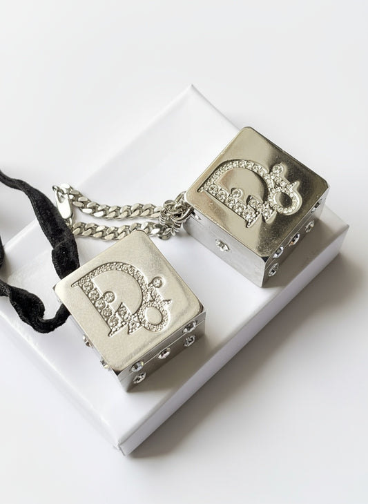 Front view of vintage Dior Play dice-shaped bag charm with silver finish and embedded crystals