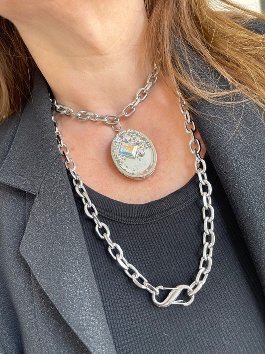 Vintage Dior Cristal Boréal locket necklace styled on a red velvet background, showcasing its elegant crystal-studded pendant and silver-tone chain. Necklace can be worn long, doubled, or adjusted for different looks.