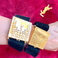 On hand worn by model two Fashion Bracelet makeup Yves Saint Laurent vintage 2000 displayed with YSL pins on a red velvet background 