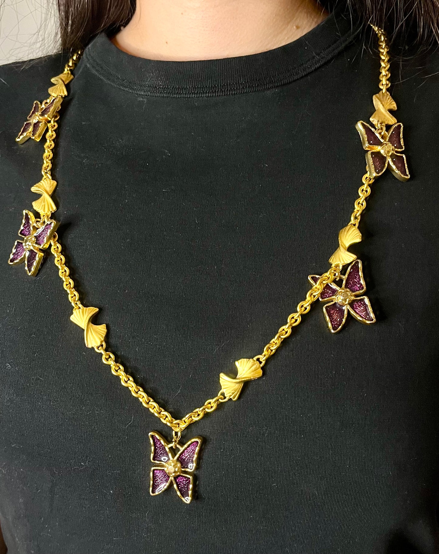 Worn by model Vintage 80s five Yves Saint Laurent Butterfly Enameled pendants mounted on a Nina Ricci gold necklace 