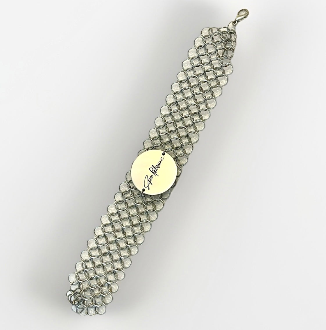 Vintage Paco Rabanne chainmail mesh bracelet silver tone On grey background 