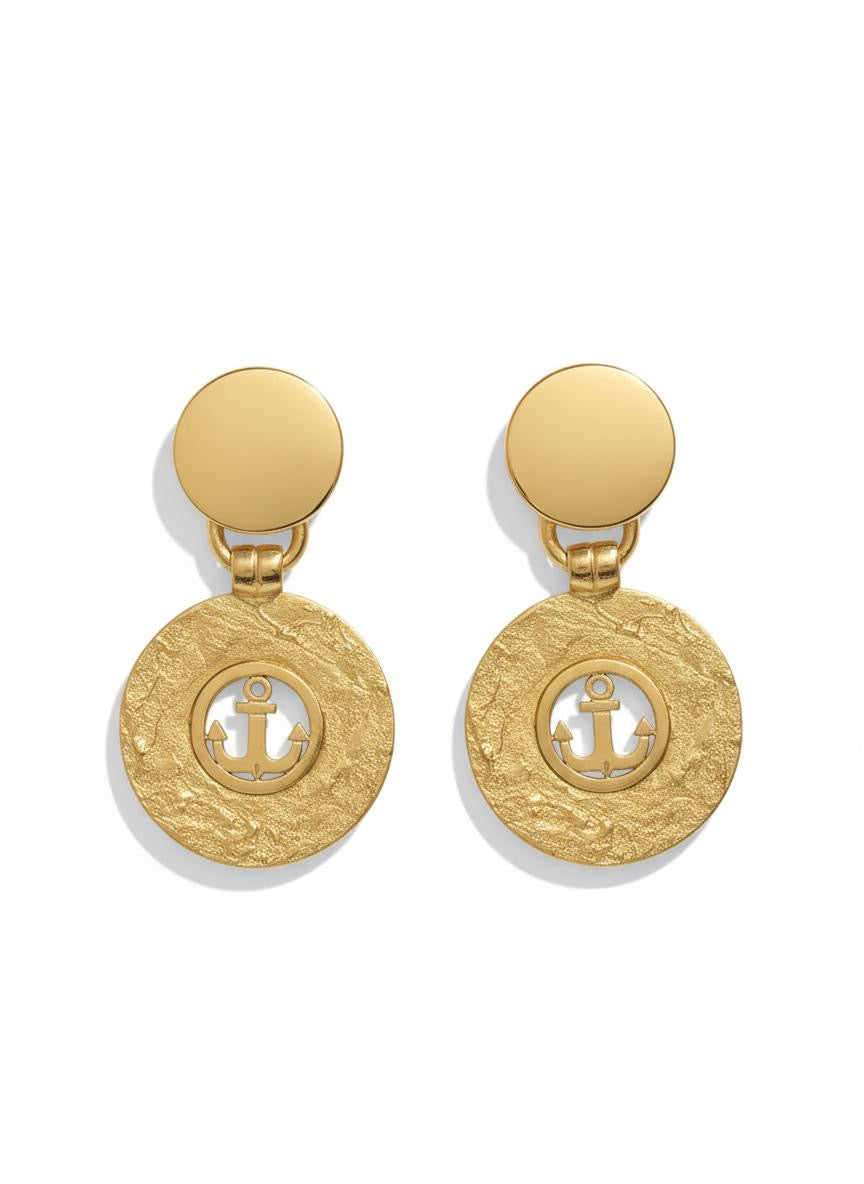 Vintage 1980s Yves Saint Laurent gold-tone anchor earrings with textured circular drop, clip-on design on white background 