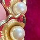 Close up details Authentic vintage Yves Saint Laurent earrings, organic gold-tone flower design with pearl accents