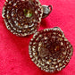 Close-up of Yves Saint Laurent Rive Gauche vintage statement earrings showing the diner authenticity tag