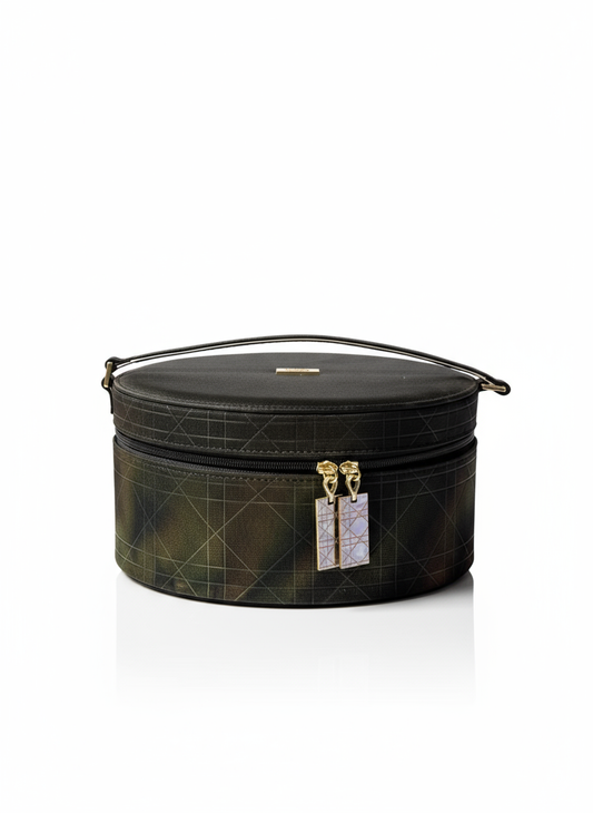 Round black Dior  travel case with gold accents on a white background